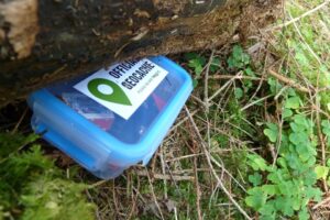 Geocache hidden under log