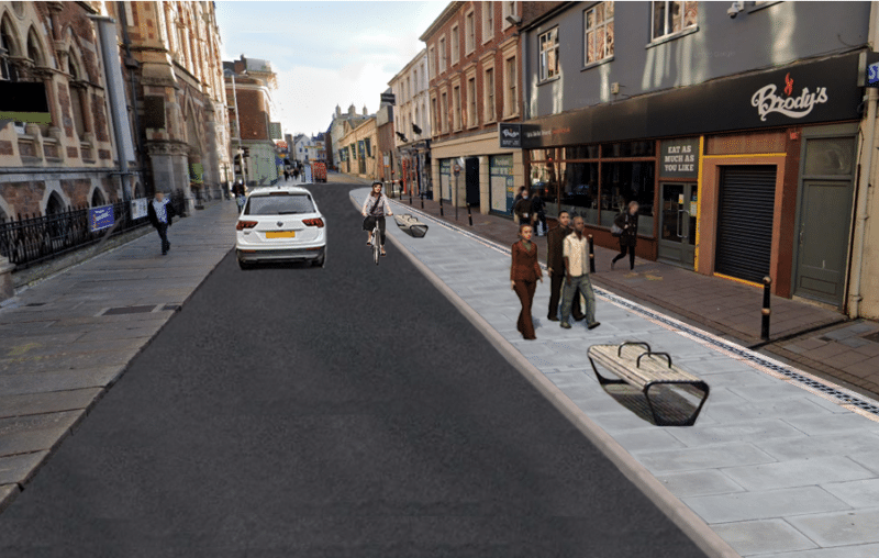 Visualisation of Queen St, with wider footway and street furniture (benches/planters) on southern side and vehicle carriageway wide enough for a car to pass a cyclist. 