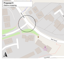 Proposal 5: Zebra crossing.” Zoomed view of the junction on Main Road with a side road beside a small green verge, near Exminster Garage. A black dashed circle highlights the proposed zebra crossing location on Main Road. North arrow at bottom left.