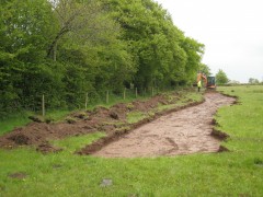 Topsoil stripping being monitored by an archaeologist