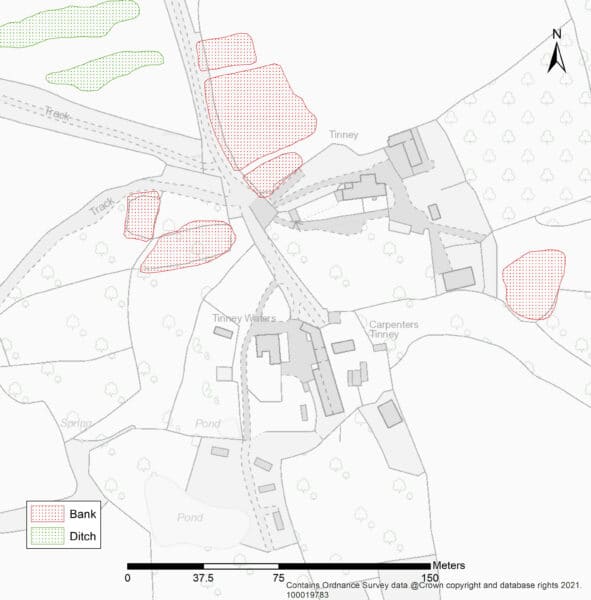 A greyscale map overlain by transcriptions of the earthwork banks, mapped as irregular areas to the north, east and west of the modern settlement.