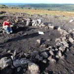 One of the Bronze Age cairns under excavation, with the outer kerb-stones exposed