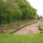 Topsoil stripping being monitored by an archaeologist