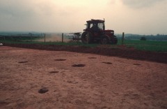 Buried archaeological features may be invisible on the surface. The pits and postholes of this Iron Age settlement near Exeter were discovered when topsoil was stripped for the new A30.