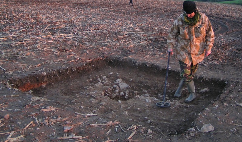 Laurence Egerton makes a final sweep of the site after the hoard has been fully excavated. © Devon County Council