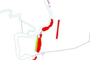 A colour map depicting a series of banks (in red) and small structures (in purple) following the east side of a river. One stretch of bank has a ditch on its west side, and cuts of a loop in the river. 