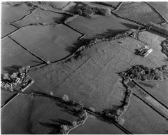 A black and white aerial photograph of prehistoric field boundary bank earthworks. 