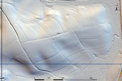 A black and white lidar visualisation of curvilinear earthwork lynchets on the north, east and south sides of a hill. 