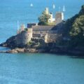 A castle on a small section of land right at the sea's edge