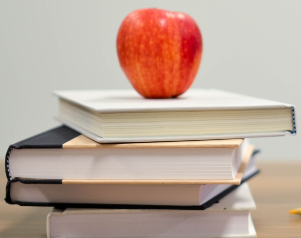 picture of textbooks with apple on top