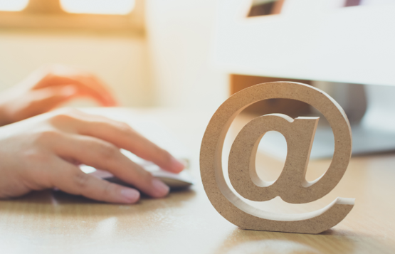 image of hand on computer mouse with wooden at symbol