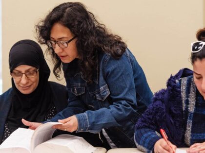 teacher helping students