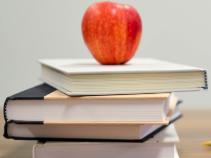 picture of textbooks with apple on top