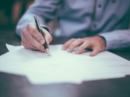 image of person writing a letter with a pen