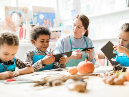 stock photo of children carving a pumpkin