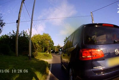 Photo of a car dangerously overtaking a cyclist