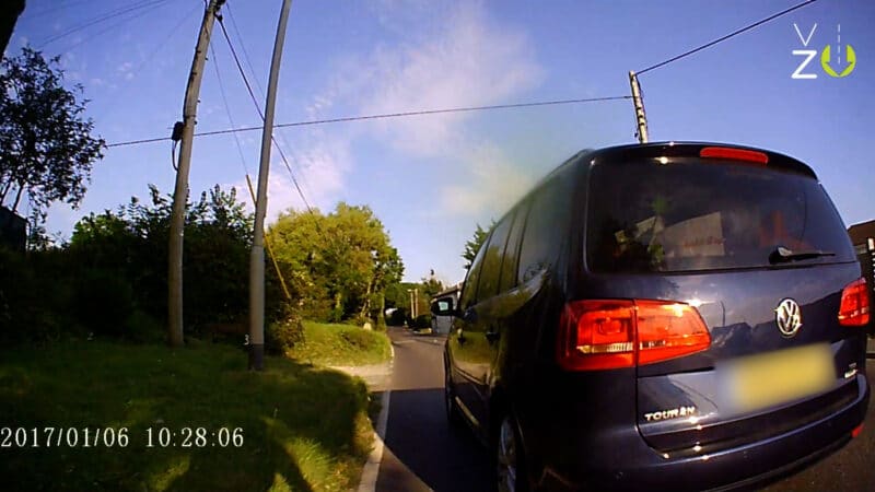 Photo of a car dangerously overtaking a cyclist