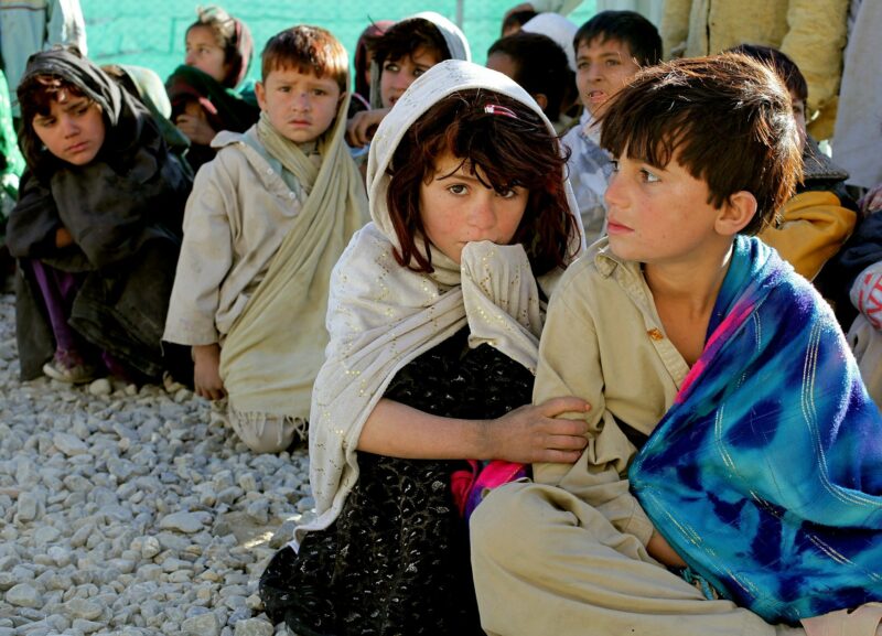 Children from Afghanistan sat on the ground