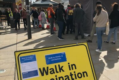 Queue of people waiting to receive their vaccination at the pop-up vaccination unit in Queen Street, Exeter