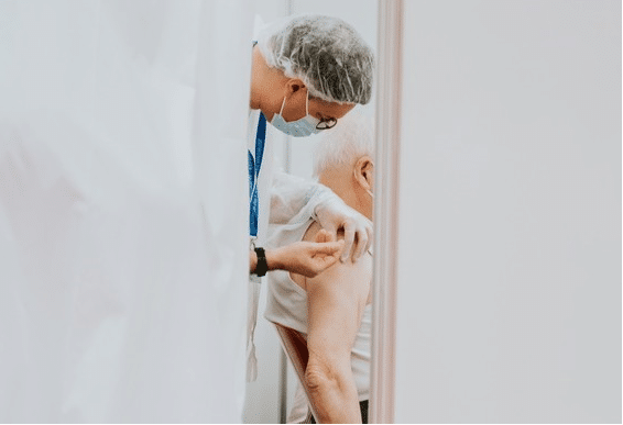 Elderly man receiving his vaccination