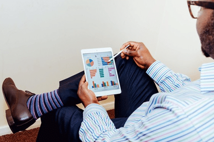 man looking at his tablet