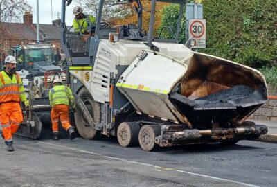Highway maintenance team laying the top layer of a road in Exeter