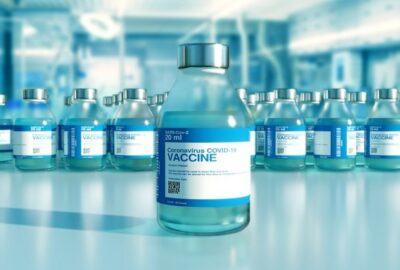 bottle of clear liquid as if in a lab, with the word 'vaccine' on the bottle