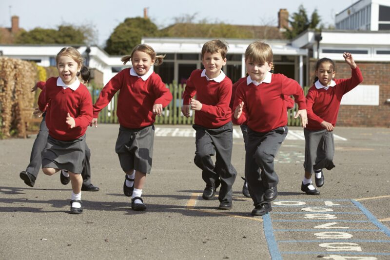 school children running in playground