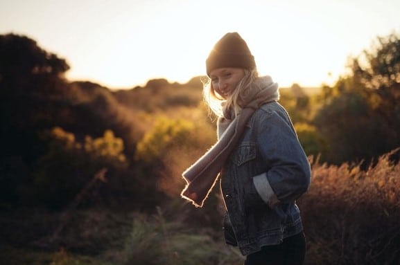 young lady, smiling, walking outdoors