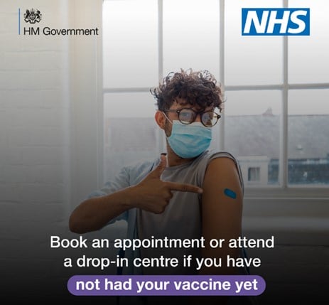 Vaccination advert - young man, wearing a face covering, having his vaccination