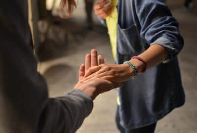 a volunteer holding their hand out to help another person