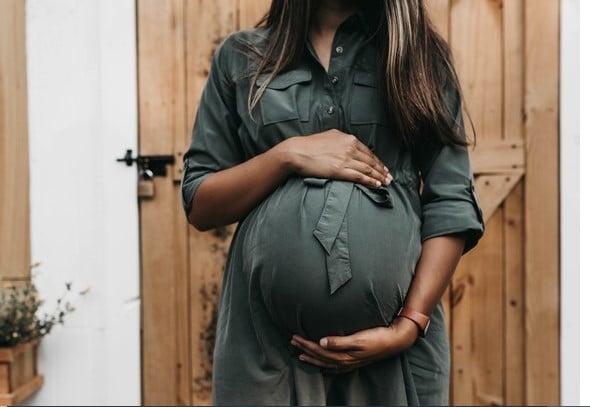 Pregnant lady, holding her tummy