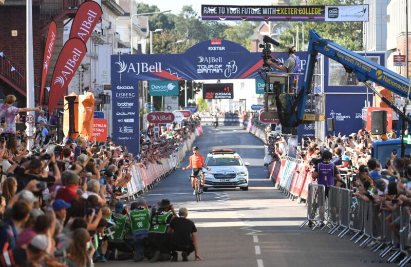 Photo of Rally Cycling's Robin Carpenter crossing the finish line in Exeter