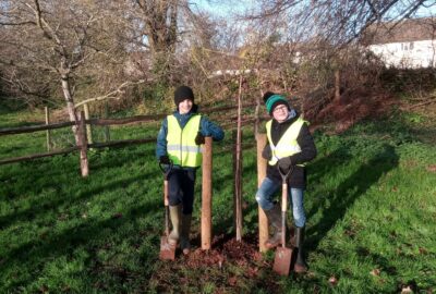 Photo of Sampford Peverell Primary pupils planting a tree at the Grand Western Canal Country Park