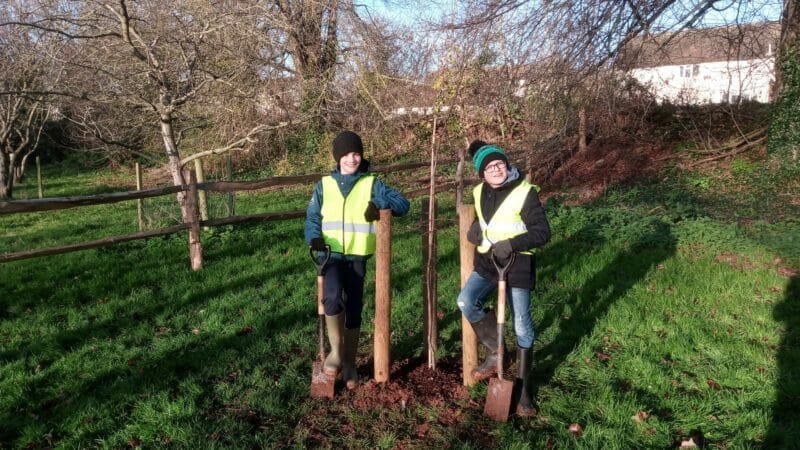 Photo of Sampford Peverell Primary pupils planting a tree at the Grand Western Canal Country Park