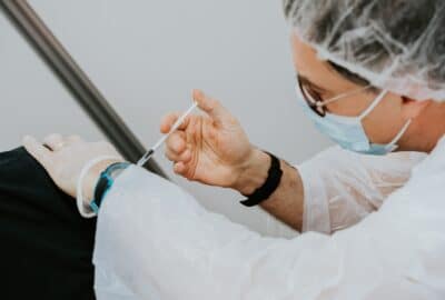a nurse injecting a shoulder