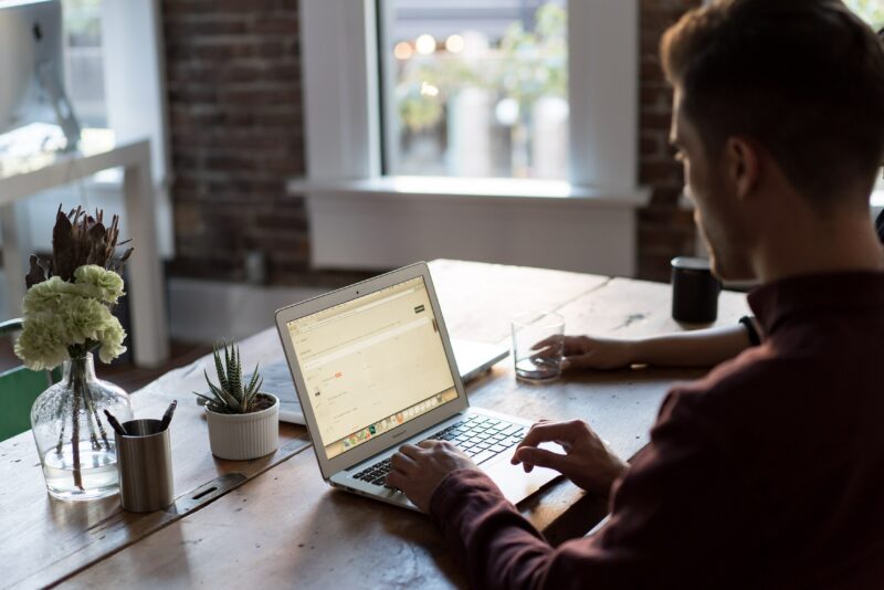 man working from his laptop at home