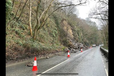 image shows rocks and debris that have slipped onto the road.