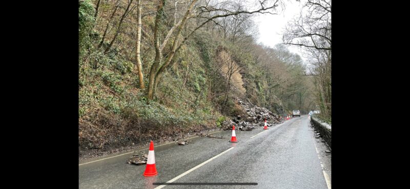 image shows rocks and debris that have slipped onto the road.