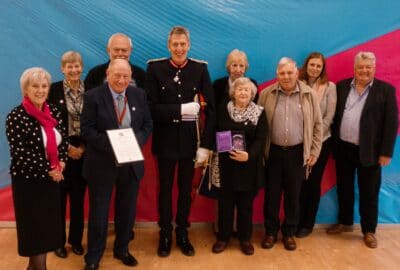 The team at Westbank receive their QAVS from the Lord Lieutenant, David Fursdon