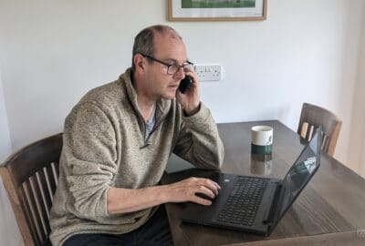 Steve, at Burcott Mill, using his phone indoors
