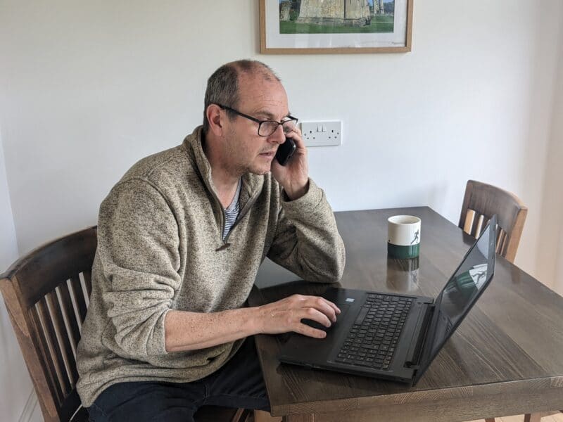 Steve, at Burcott Mill, using his phone indoors