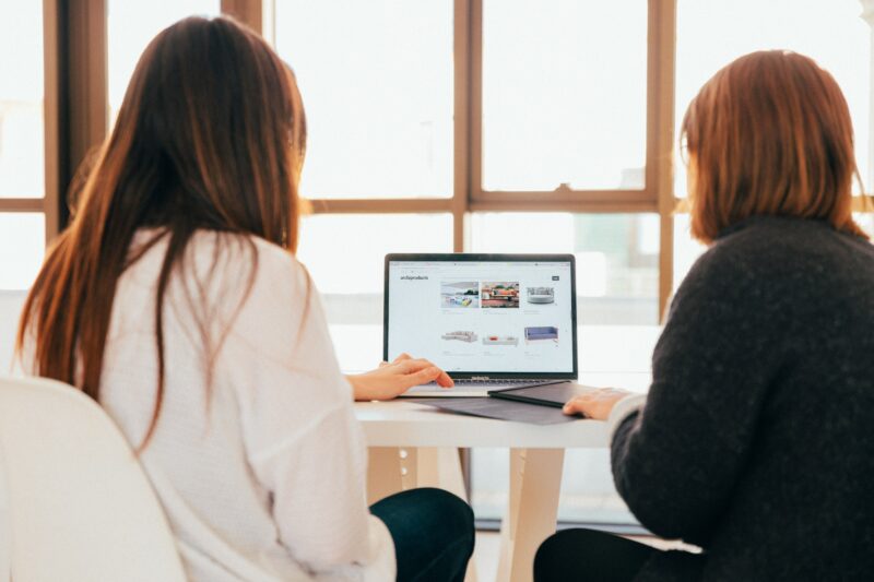 Two women working at a computer