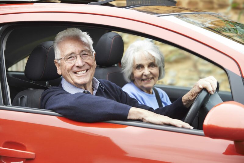 elderly man and women in car