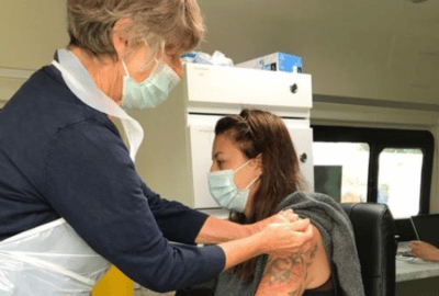 Lady receiving her vaccination at a pop-up clinic