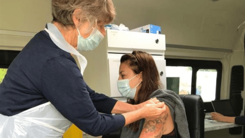 Lady receiving her vaccination at a pop-up clinic