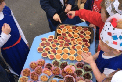 Children at Swimbridge C of E Primary School with jam tarts and crispy cakes that they've made