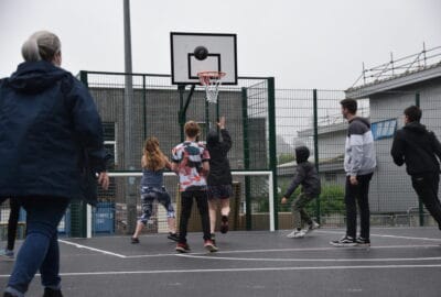 Young people playing basket ball on the new Multi Use Games Area in Newton Abbot