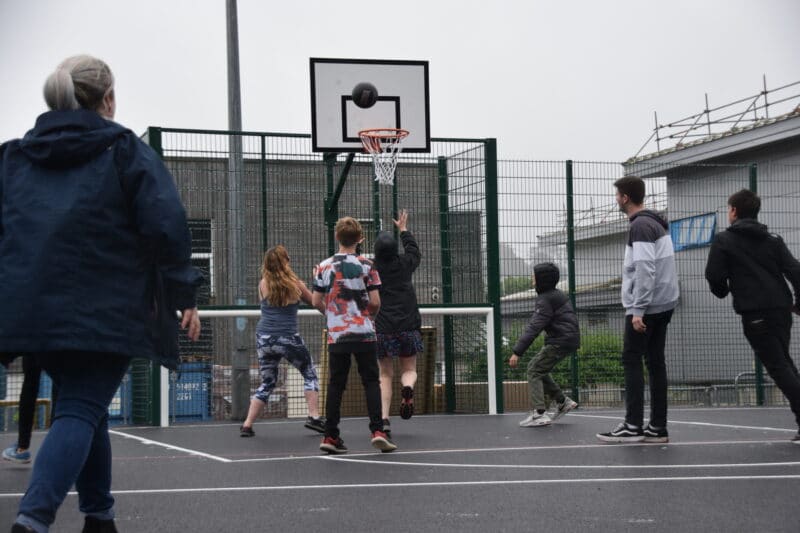 Young people playing basket ball on the new Multi Use Games Area in Newton Abbot