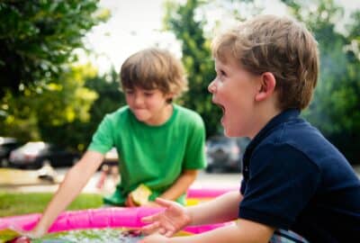 Two young boys playing outside in the garden